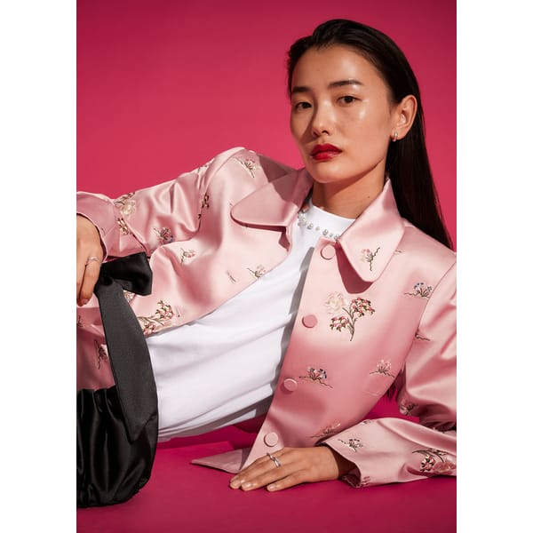 model wears pink floral stain jacket