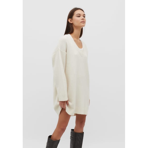 model wears cream knit dress