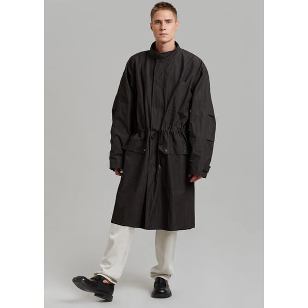 male model wears black parka