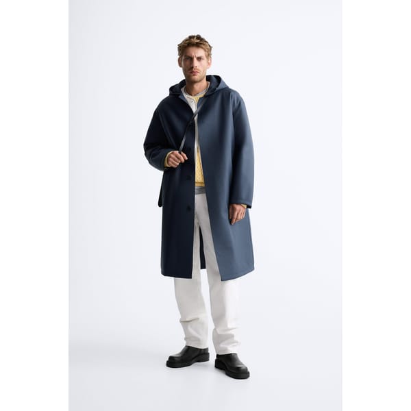 model wears navy rubber parka