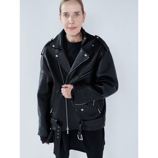 model wears black leather jacket