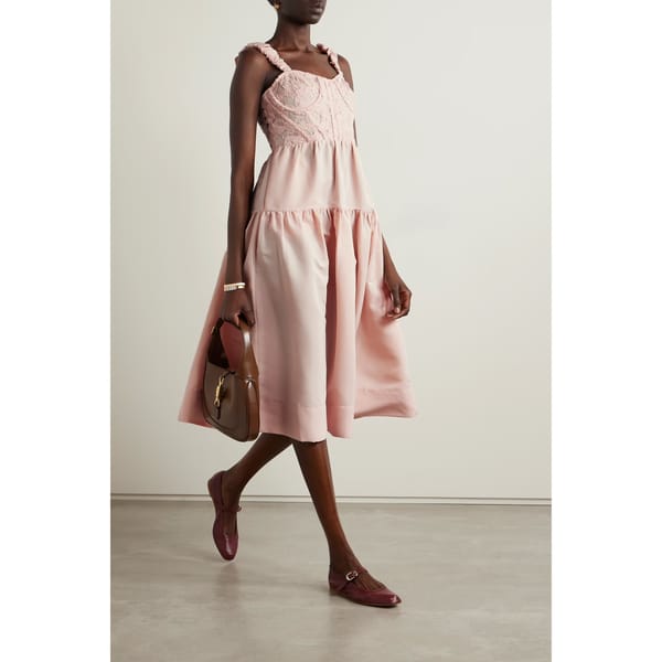 model wearing pink embroidered taffeta midi dress