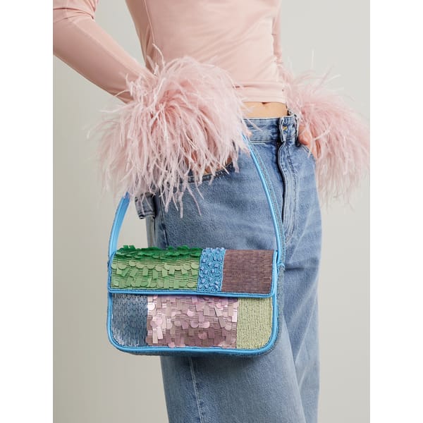 close up of model holding embellished bag