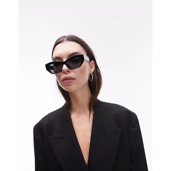 model wears black angular sunglasses