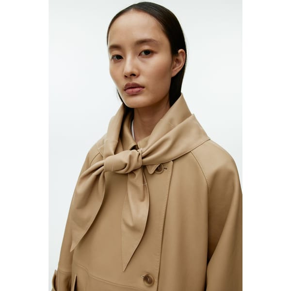 model wears leather scarf