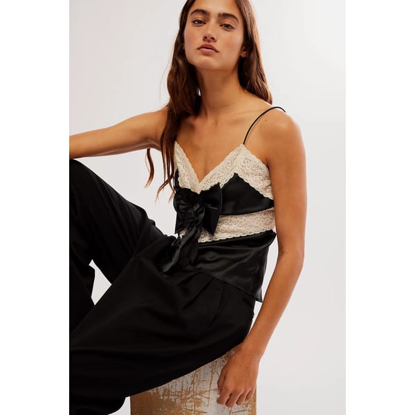 model wears black and white lace cami top