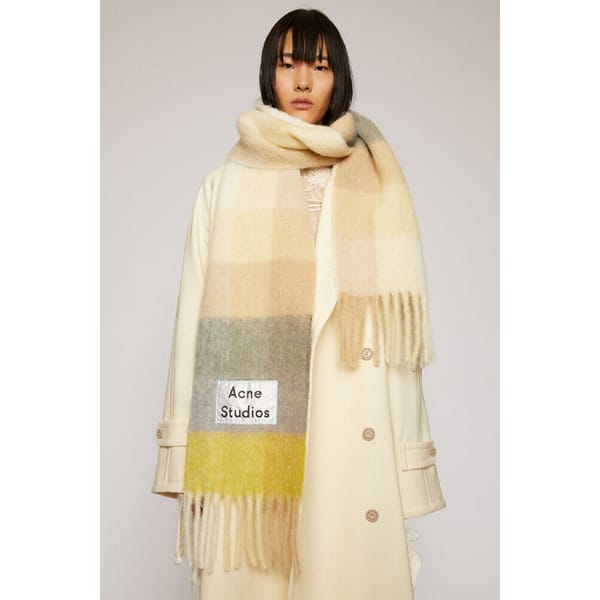 model wearing checked acne scarf and coat