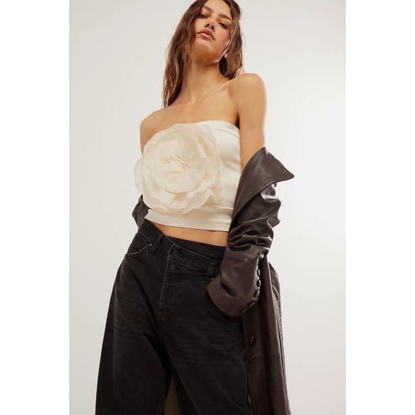 model wears cream top with flower detail