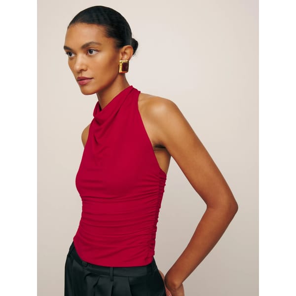 model wears red knit halterneck top