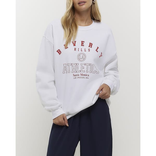 model wears cream cotton logo sweatshirt
