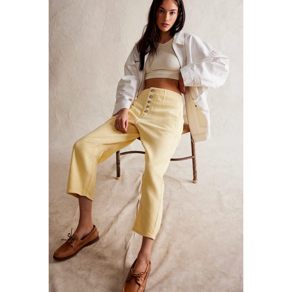 model on chair in yellow jeans