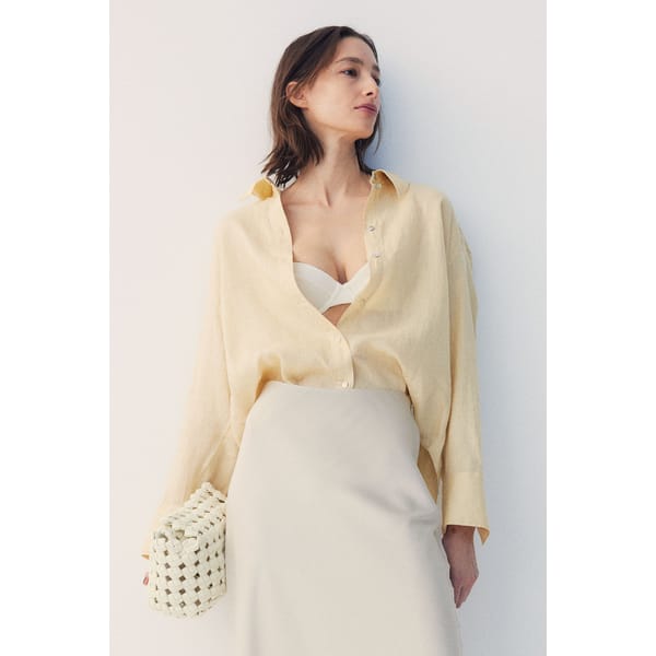 model wears pale yellow linen shirt