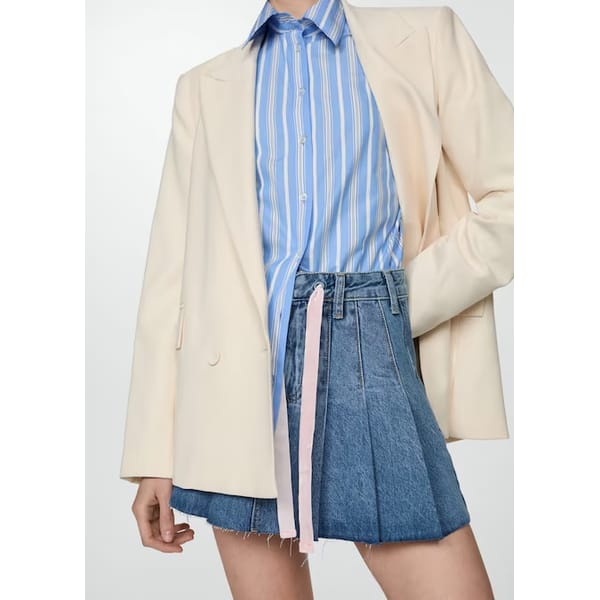 model wears pleated denim skirt