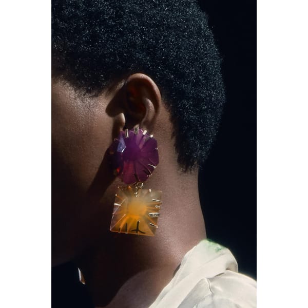 model wears big coloured resin earrings