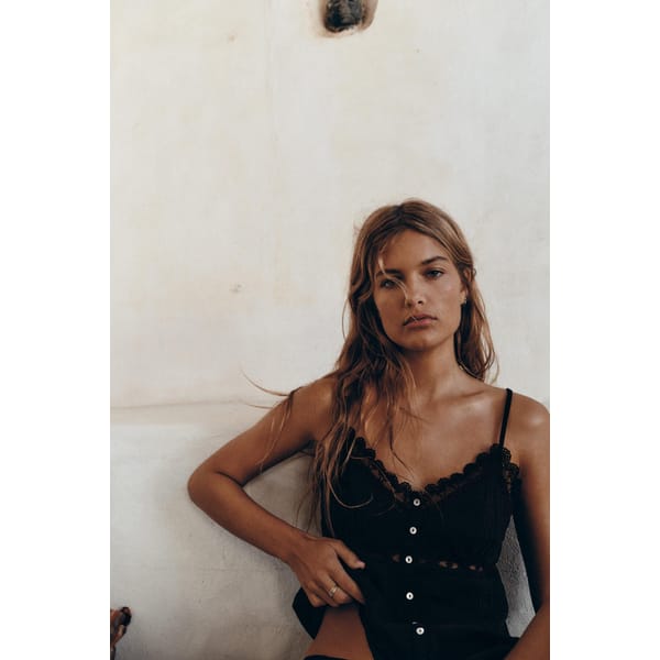 model wears black lace embroidered top