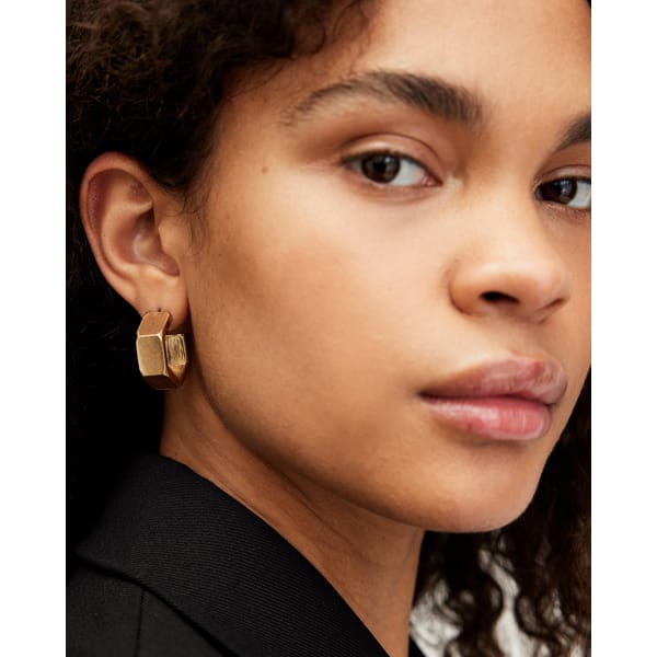 model wears Alex Hexagon Hoop Earrings in gold