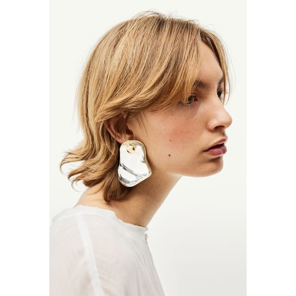 model wears Asymmetric stud earrings