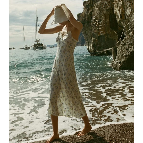 model on beach wearing floral dress