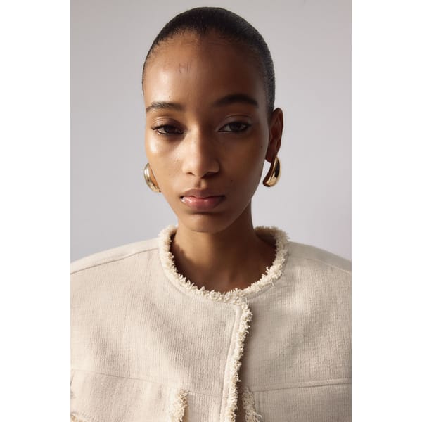 model wears gold chunky earrings