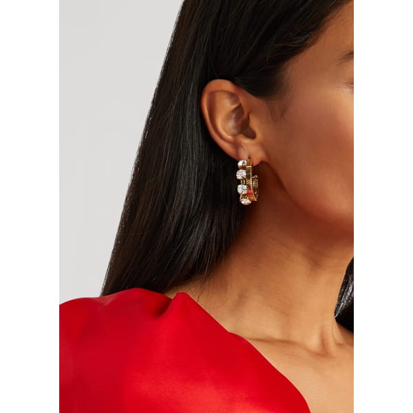 close up of model wearing Circe crystal-embellished hoop earrings