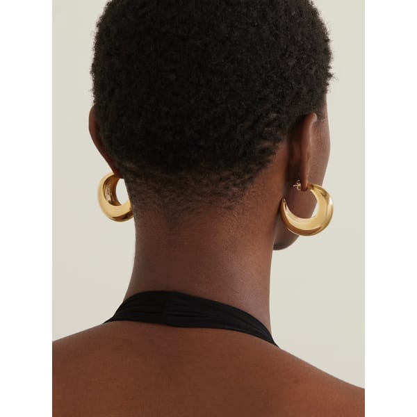 back of model's head wearing ISABEL MARANT Crescent gold-tone earrings