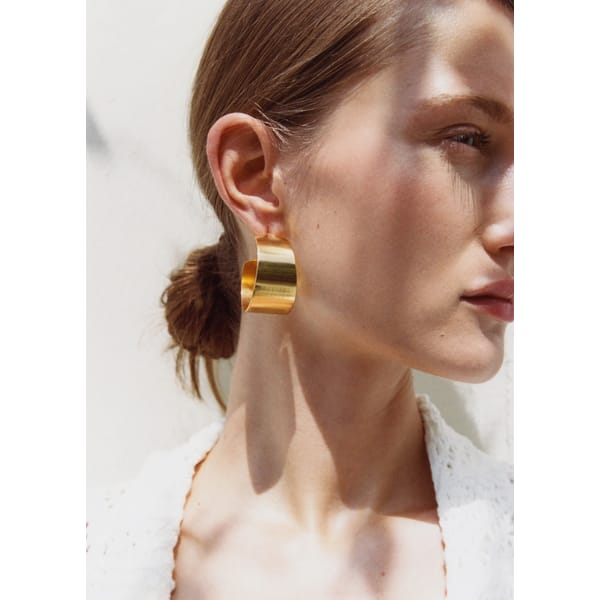 MODEL WEARING VOLUME HOOP EARRINGS
