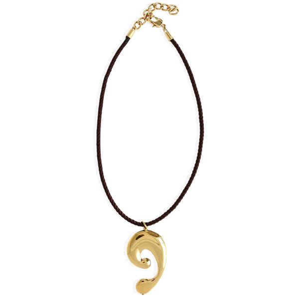 gold shell necklace on black rope