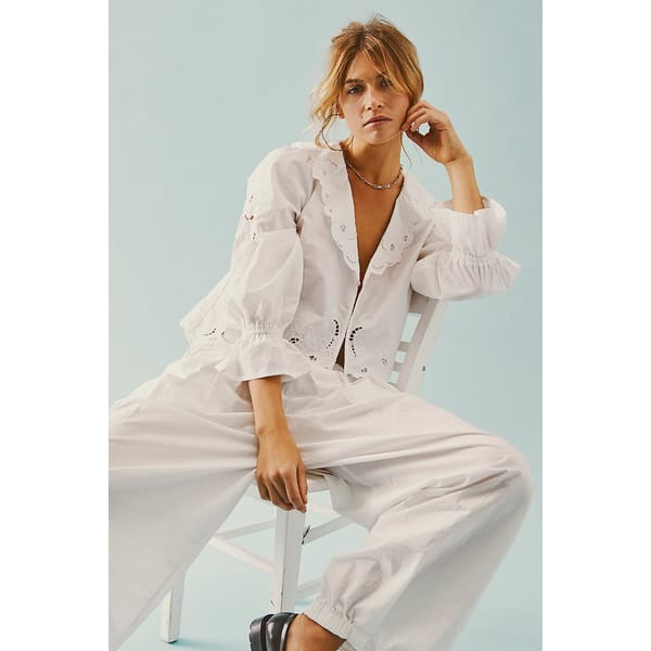 model sitting wearing FP Maisie Cutwork Top in white