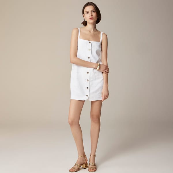 model wearing white mini button through dress