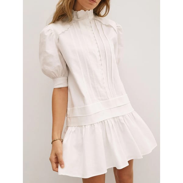 model wears white vita grace Mellania Scalloped Edge Linen Day Dress