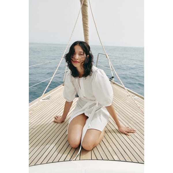 model on boat wearing zara ZW COLLECTION STRIPED POPLIN DRESS