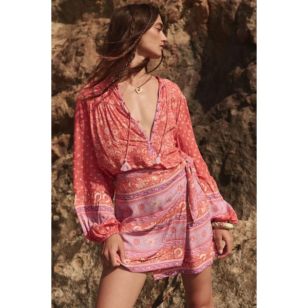 model on beac wearing SPELL Sunshine Bandit Wrap Mini Skirt Cayenne