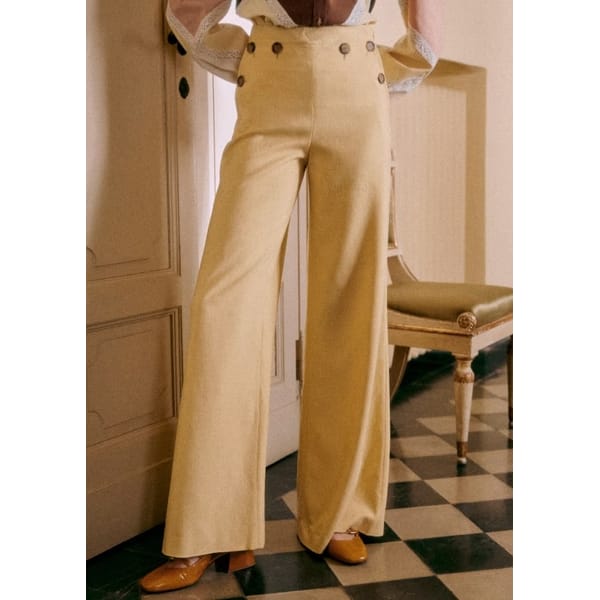 close up of model wearing yellow trousers