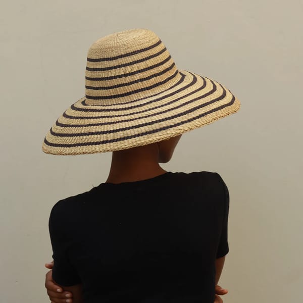 model wears striped straw hat