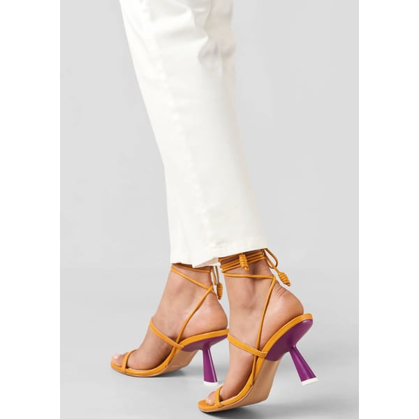 model's feet wearing Alohas Kendra Leather Sandals - Bicolor Yellow Purple