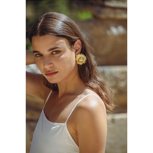 model wearing sun gold earrings