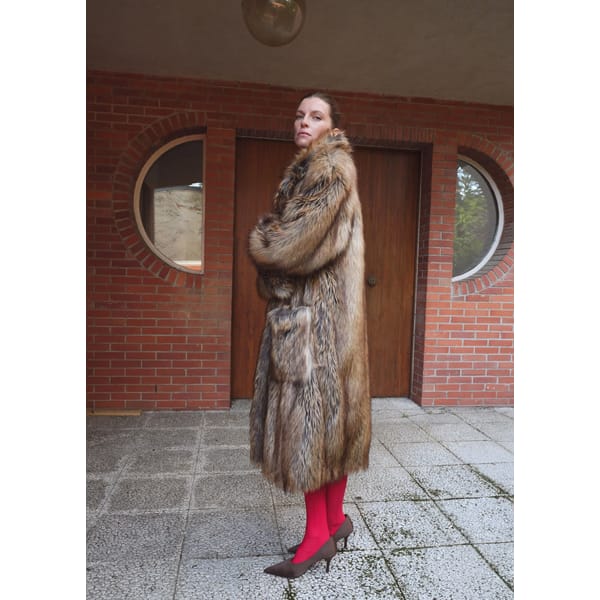 model wearing faux fur coat and red tights