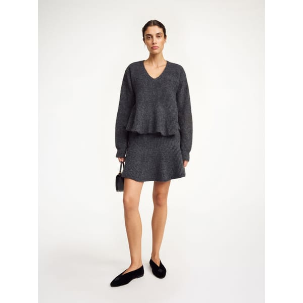 model wearing grey knit skirt and top co-ord