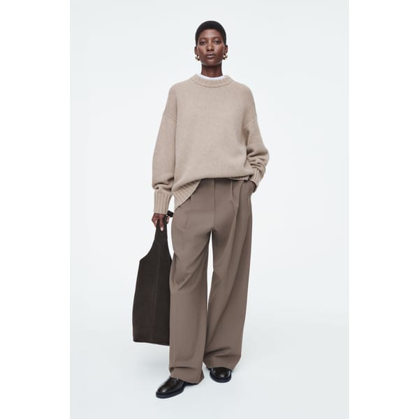 model wearing COS CHUNKY PURE CASHMERE CREW-NECK JUMPER in biscuit shade