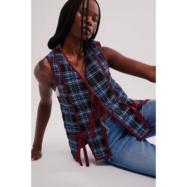 model sitting on floor wearing DAMSON MADDER Damson Madder Aliva Bow Gilet