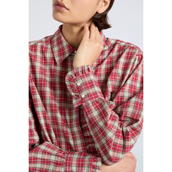 close up of model wearing tartan ruffled shirt