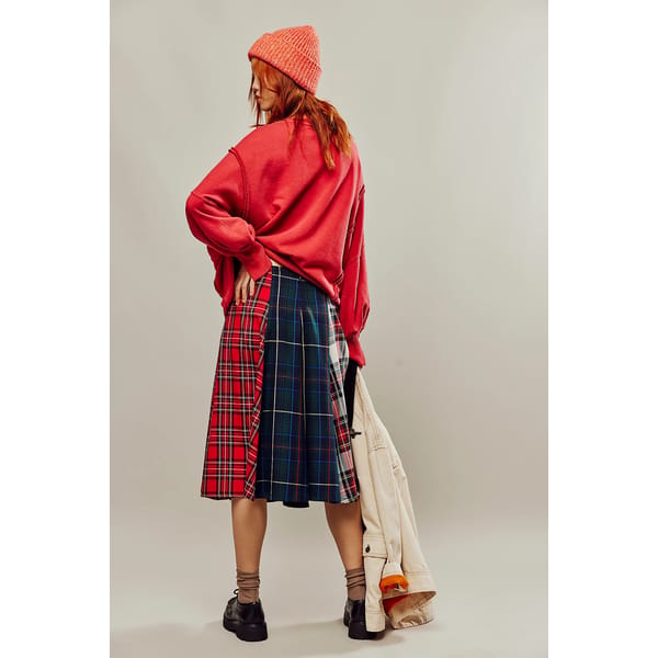 model's back wearing tartan skirt
