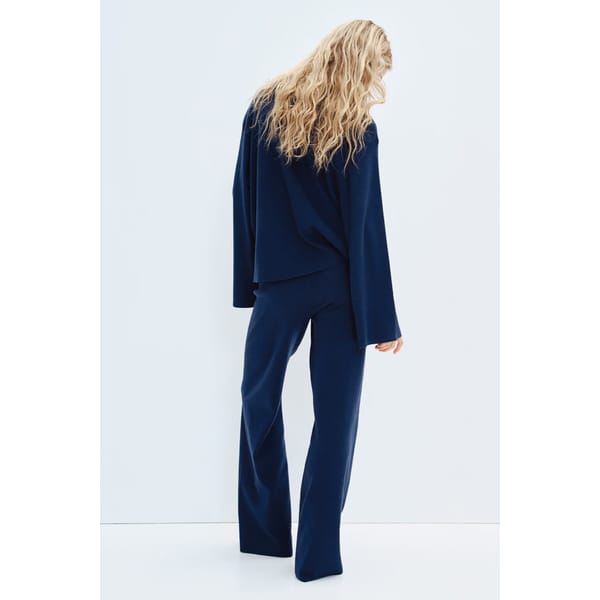 model from back wearing navy co-ord set