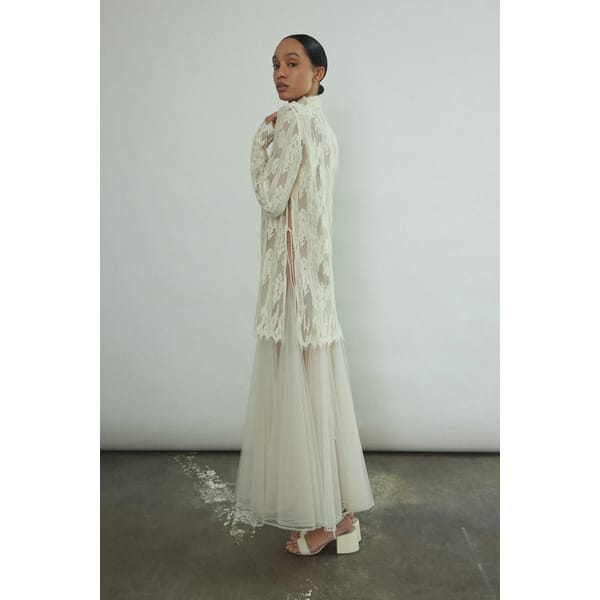model wears Isabella Tunic Cream wedding dress