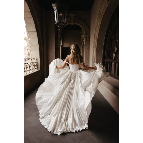 model running from back in wedding dress