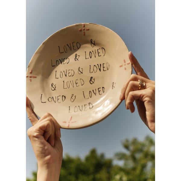 hands holding up loved plate