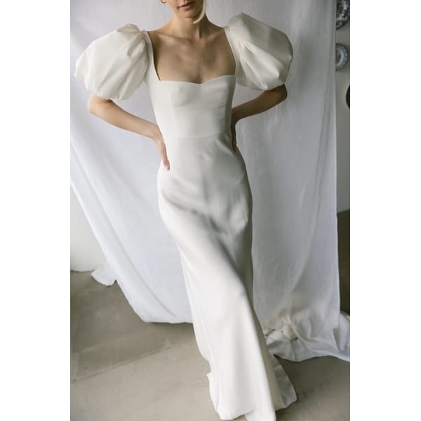 model wearing white puff sleeve dress