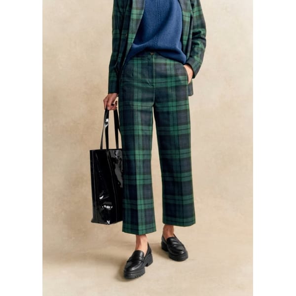 close up of model wearing Sézane Martin Crop Trousers in green and navy tartan