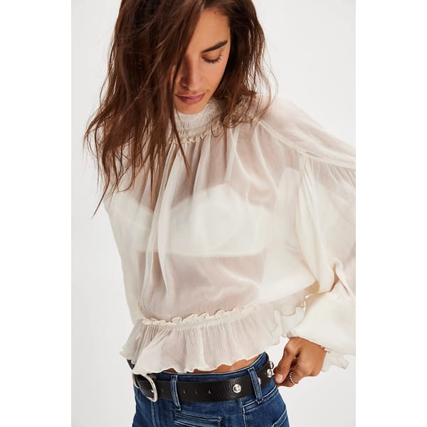 model wearing white sheer blouse