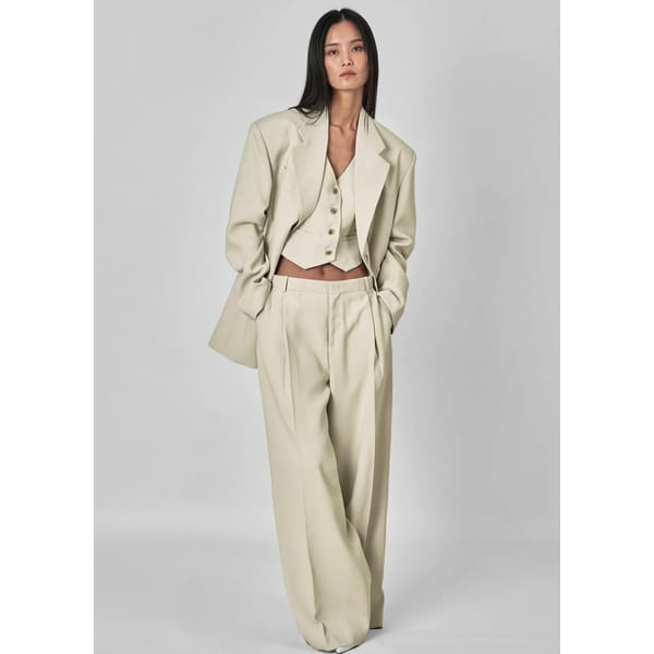 model wearing cream suit